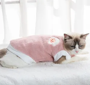 Close-up detail of soft plush cat vest in pink and white, warm winter pet apparel.