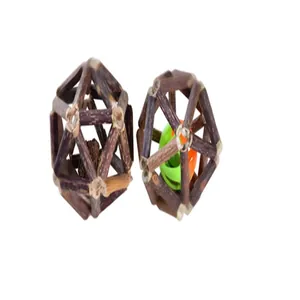 A close-up view of two handmade woven silvervine cat balls featuring a gall fruit and a bell