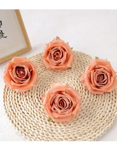 Artificial rose flower heads close-up, warm orange color, ideal for DIY wedding decor.