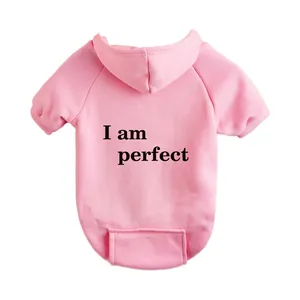 Detailed view of pink fleece pet hoodie with text print, comfortable dog sweatshirt for autumn.
