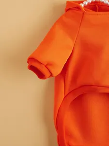Orange fleece pet hoodie detail shot, warm two-leg dog and cat apparel with pearl decor.