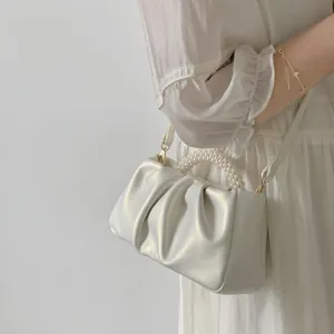 Sweet pearl handle pleated crossbody cloud bag for women, stylish mini white handbag detail.