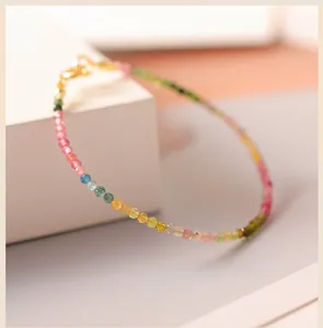 Close-up of 2mm faceted rainbow tourmaline beads on a delicate gold bracelet