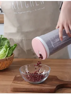 Action shot of pink lid plastic kitchen storage jar pouring red beans into a bowl