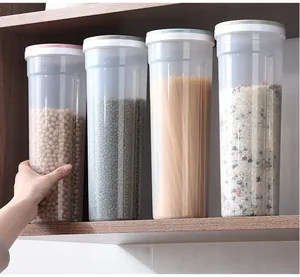 Transparent tall food storage jars organized on kitchen shelf with pasta and grains
