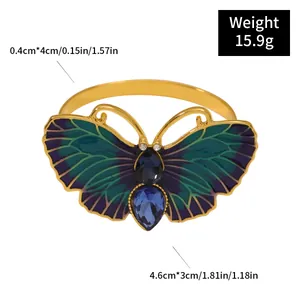 Elegant butterfly napkin ring with blue enamel and rhinestones for dining table decor.