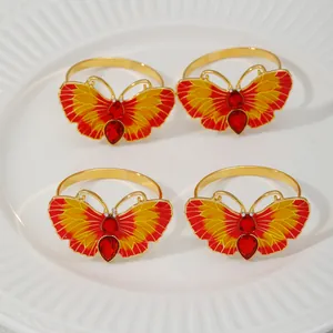 Butterfly napkin rings with red yellow enamel and sparkling rhinestones for chic table decor.