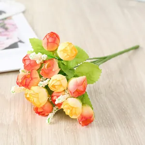 Detailed view of artificial miniature rose flower bouquet with vibrant orange and yellow buds.