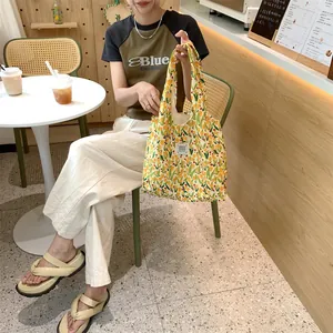 Canvas floral tote bag detail showing green tulip pattern and large capacity for daily use.