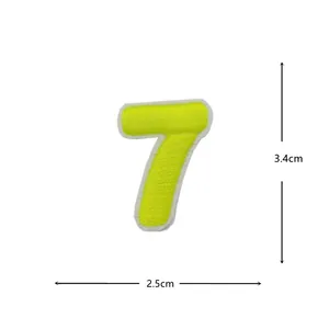 Detail view of a fluorescent yellow embroidered number 7 cloth patch with white border.