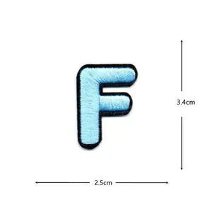 Light blue letter F embroidery patch detail showing precise stitching and edges.