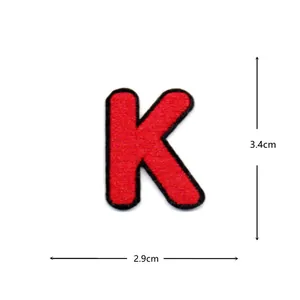 Red letter K embroidered patch iron on garment accessory clothing repair badge detail view.