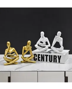 Figuras decorativas de pensadores abstractos de resina leyendo libros en acabados oro y blanco