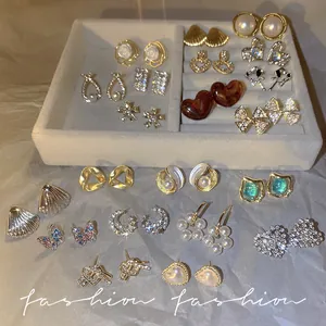 Elegant collection of S925 silver needle zircon and pearl stud earrings displayed in a tray