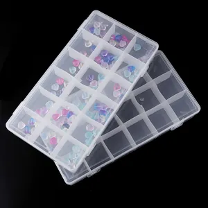Clear compartmentalized plastic storage box detail showcasing multi-grid design and beads.