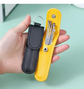 Detailed view of portable stainless steel ear pick set with colorful leather storage cases.