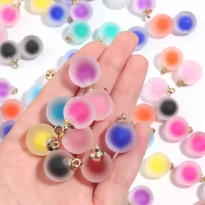 Close-up detail of colorful frosted acrylic candy heart round bead pendants with gold loops.