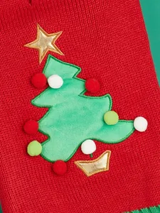 Red knit pet sweater detail with cute Christmas tree embroidery, pom-poms, and gold star design.