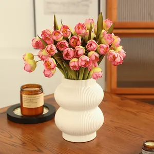 Artificial flower bouquet in white ceramic vase, elegant home decor for living room table.