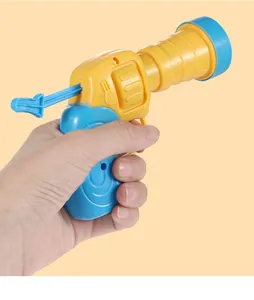 Close-up of yellow and blue cat toy plush ball launcher being held by hand