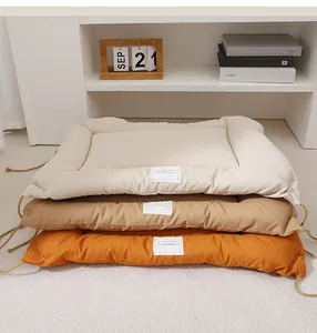 Detailed view of soft thick pet mat with raised edges and tie ropes in multiple colors.