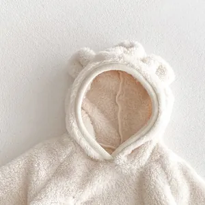 Cozy fleece baby hooded romper detail with cute bear ears and soft plush texture.