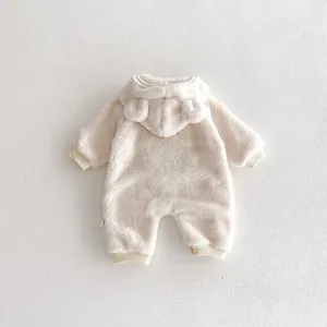 Close-up detail of cozy infant fleece hooded romper with cute bear ears and ribbed cuffs.