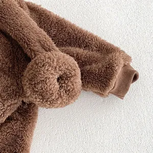Detailed view of soft cozy fleece baby romper sleeve and cute fuzzy hoodie detail, warm.
