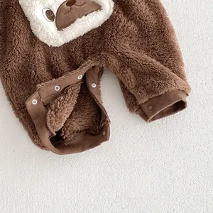 Baby fleece romper detail, soft warm brown onesie with cute animal face and snap buttons.
