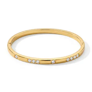 Detailed macro view of 18k gold plated bangle with sparkling cubic zirconia inlay