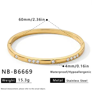 Detailed view of 18k gold-plated stainless steel bangle with cubic zirconia specs
