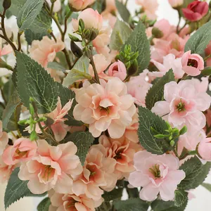 Detailed view of artificial rose flower bouquet with vibrant pink petals and green leaves.