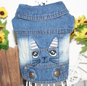 Detail of denim pet vest featuring cute cat embroidery and antique metal buttons