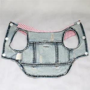 Detail view of distressed light blue denim pet vest with red striped collar lining