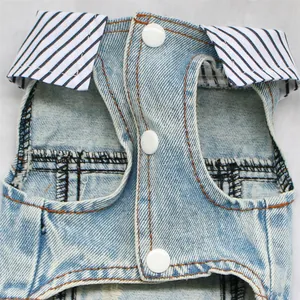 Macro close-up detail of denim pet vest with striped collar and white snap buttons