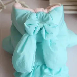 Detail view of the cute rabbit ears and bow on a padded pet winter coat
