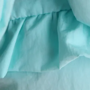 Macro detail of soft light blue polyester fabric lining for a thickened dog winter coat