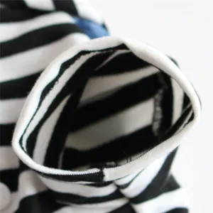 Close-up of black and white striped sleeve with white ribbed cuff on pet dress