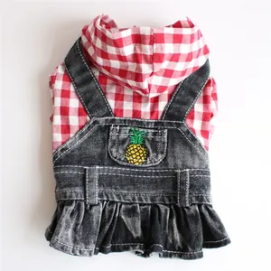 Detail view of pet denim skirt featuring red checkered hoodie and pineapple embroidery
