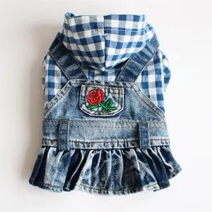 Detailed view of red rose embroidery on a blue checkered pet denim overall dress