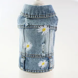 Close-up detail of embroidered white daisies on light blue distressed denim pet dog vest