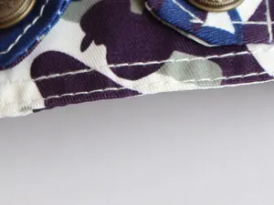 Macro detail of purple camouflage pet vest showing high-quality stitching and fabric