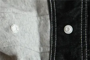 Vista macro dettagliata dei bottoni automatici e del tessuto denim su gilet per cani