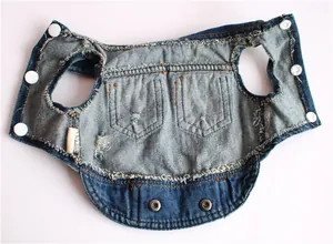 Detailed view of blue distressed denim pet vest with two pockets and snap buttons.