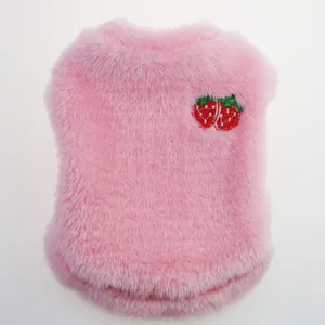 Close-up of pink plush dog vest featuring a cute red strawberry embroidery detail.