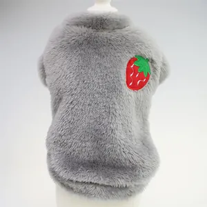 Detailed macro view of a grey plush pet vest featuring a cute strawberry embroidery