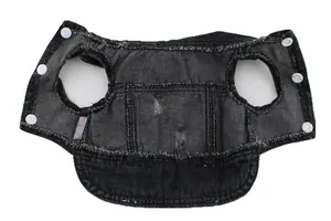 Close-up detail of a black distressed denim pet vest featuring white snap button closures
