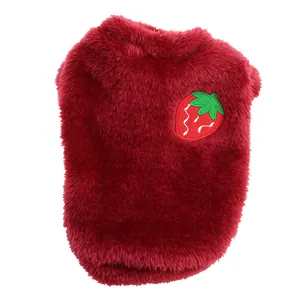 Detail view of the deep red plush pet vest with a cute strawberry embroidery patch.