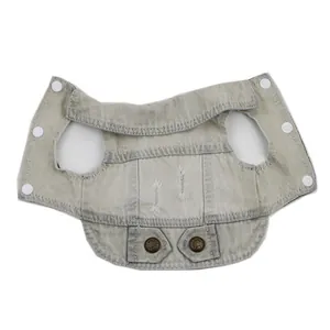 Close-up flat lay of a light grey distressed denim pet vest with white snap buttons