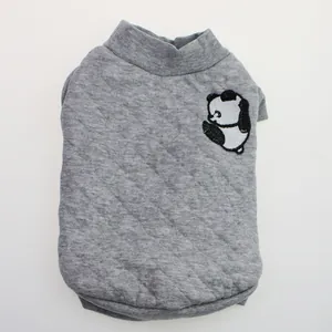 Detailed macro view of a grey quilted dog sweater with a cute panda embroidery